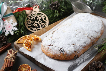 Christmas tasty stollen with dry fruits, berries and nuts on wooden board. Traditional German treats.