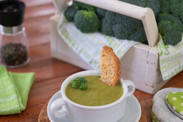 Broccoli. A green cream soup of broccoli  for a healthy eating without calories but with vitamins. Concept of healthy nutrition. Wooden background