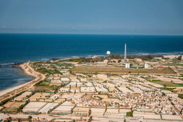 high view from Thoi Loi Mountain, fishing village and garlic fields at Ly Son island, Quang Ngai Province, Viet Nam