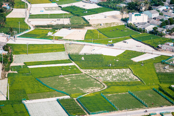 high view from Thoi Loi Mountain, fishing village and garlic fields at Ly Son island, Quang Ngai Province, Viet Nam