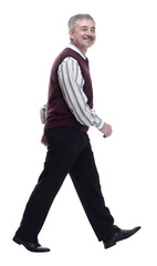 smiling mature man striding forward. isolated on a white