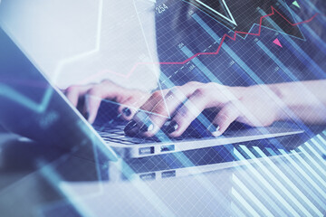 Double exposure of woman hands typing on computer and forex chart hologram drawing. Stock market invest concept.