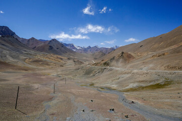 View with pastel colors of mountains towards the north from high-altitude Pamir Highway at Ak Baital pass in Murghab district, Gorno-Badakshan, Tajikistan