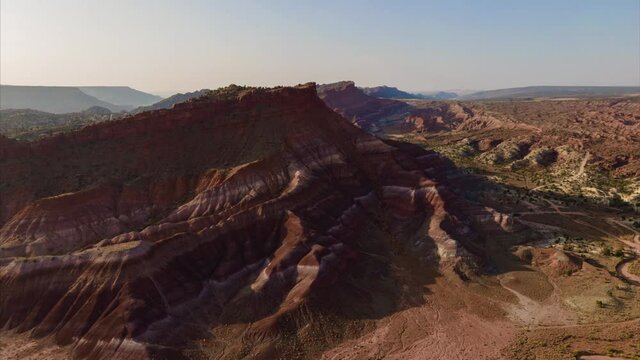 Aerial hyperlapse of colorful sandstone strata at sunrise in Southern  Utah
