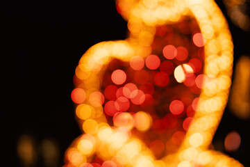 Golden red orange heart shaped bokeh blurred holiday background, valentines day postcard