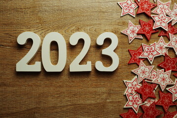 2023 Happy new year with white and red star ornament decoration on wooden background