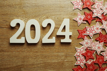 2024 Happy new year with white and red star ornament decoration on wooden background