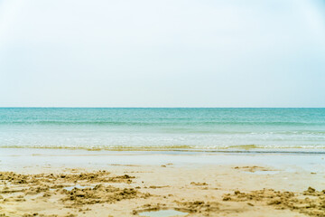 Fototapeta na wymiar Sea and sand under a blue sky