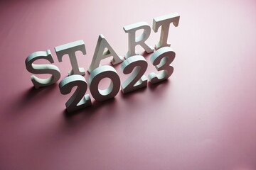 Start 2023 alphabet letter on pink background