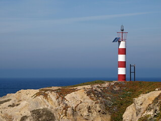 Fototapeta na wymiar Little red white lighttower on the Alentejo west coast in Portugal 