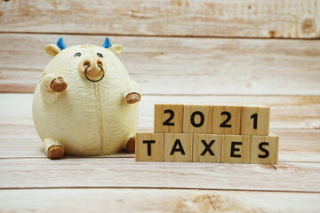TAX 2021 alphabet letter on wooden background