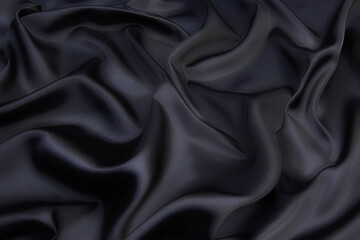 Abstract black color silk chiffon fabric texture. A mockup of silk tissue as background at  the...