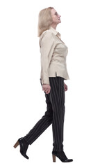 confident woman in fashionable trousers striding forward