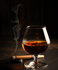 Rum in glasses with a bottle of rum and a cigar in the background.