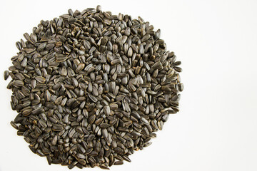 Sunflower seeds close-up and macro on the white background, large group of seeds