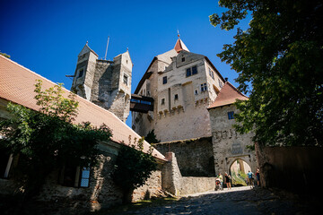 Gothic imposing historic castle Pernstejn at sunny summer day, stronghold on rock above village of Nedvedice, South Moravian Region, Czech Republic