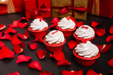 rose petals and valentines cupcakes isolated on black