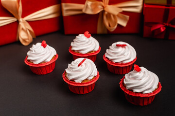 valentines cupcakes and blurred gifts on background isolated on black