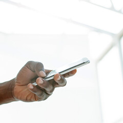 close up. young man looking at the screen of his smartphone.