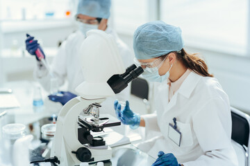laboratory technician conducts testing in the laboratory .
