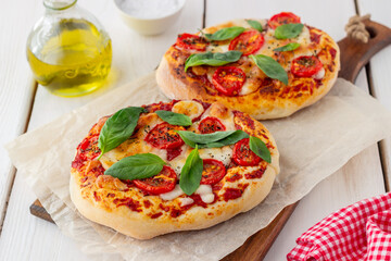 Italian focaccia or pizza with mozzarella, tomatoes and basil. Healthy eating. Vegetarian food.