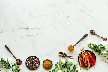 Kitchen utensils with spice and herbs in metal bowls, overhead
