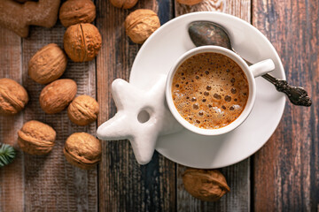 Hot nutty cappuccino with caramel and gingerbread Christmas cookies on a rustic table. Homemade sweet pastries. Top view