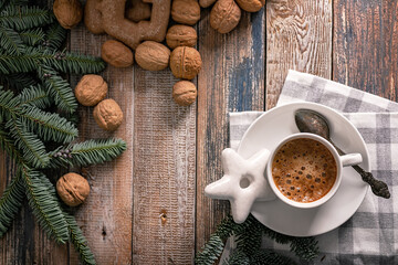 Hot nutty cappuccino with caramel and gingerbread Christmas cookies on a rustic table. Homemade sweet pastries. Top view. Copy space