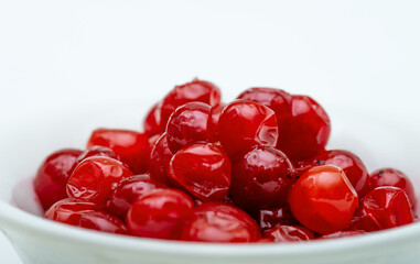 close-up of mashed thawed juicy viburnum berry, in a white saucer, in on a white background