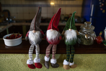 three cute puppets of gnomes used as Christmas decorations