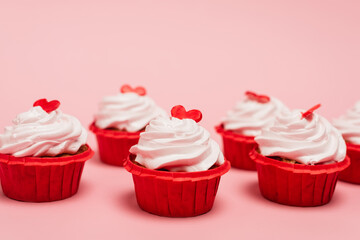 valentines cupcakes with red heart on pink background