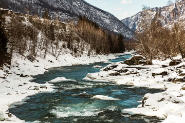 Winter Altai, ice-free Katun river and mountains covered with snow. Altai Republic, Russia