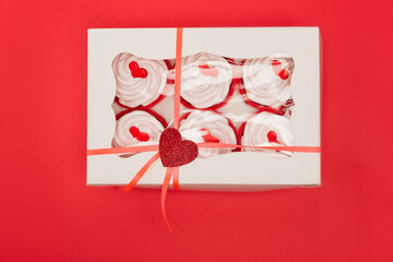 Top view of box with valentines cupcakes isolated on red