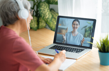 Fototapeta premium Senior woman is using laptop