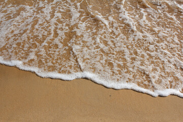 Fototapeta na wymiar Sand beach and spume