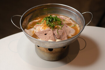 Fine sliced beef in aromatic broth