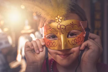 Tuinposter Young Caucasian girl with a carnival mask © Pav-Pro Photography 