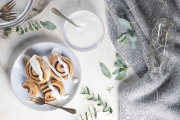 Cinnamon rolls or cinnabon  with icing for Christmas. Homemade traditional winter festive dessert buns. Pastry food for breakfast on white background