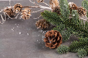 Christmas background, green pine branches  and cones on wooden background and light. Creative composition with border and copy space, top view. New Years, holiday, christmas, decoration