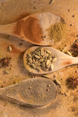 Spices and seasoning on wooden spoons in a creative and messy way