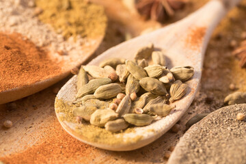 Spices and seasoning on wooden spoons in a creative and messy way