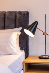 A modern bedside lamp on a side table