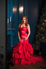 Christmas party, modern woman celebrate,  lifestyle. Girl in luxury red dress with feathers, inspirations and New Year