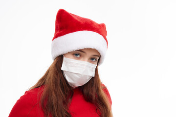 Fototapeta na wymiar girl wearing a medical mask Santa hat red t-shirt attractive look close-up 
