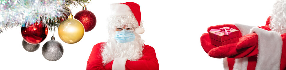 Obraz na płótnie Canvas Angry Santa Claus wearing medical mask, arms crossed on his chest. Close up shot of another Santa's hands extending a Christmas gift box to him. Isolated, white background. Pandemic holiday concept