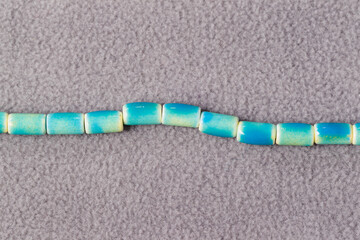 a stand of round blue beads for the creation of jewelry