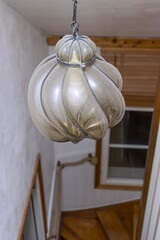 Close up interior view of very old vintage dusty lamp in silver color. Home interior backgrounds.