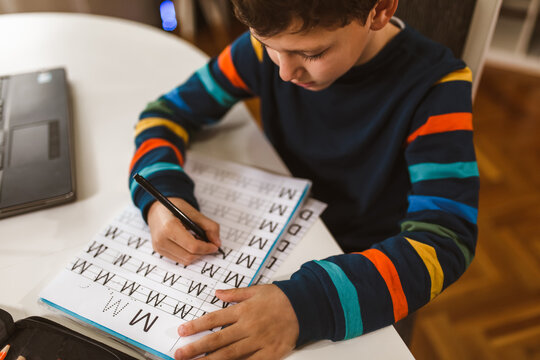 Child Practicing Writing At Home.