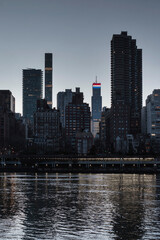 View of Manhattan skyline from the riverside at dusk