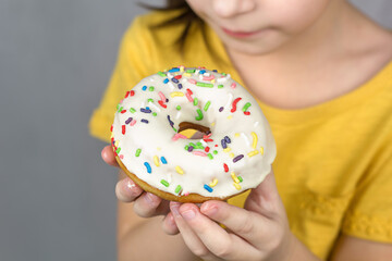 close up of hands hold a glazed white doughnut